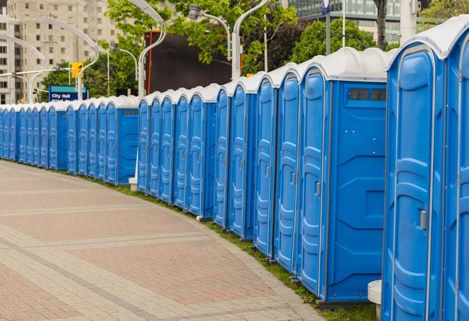 a row of portable restrooms at an outdoor special event, ready for use in Grafton WI